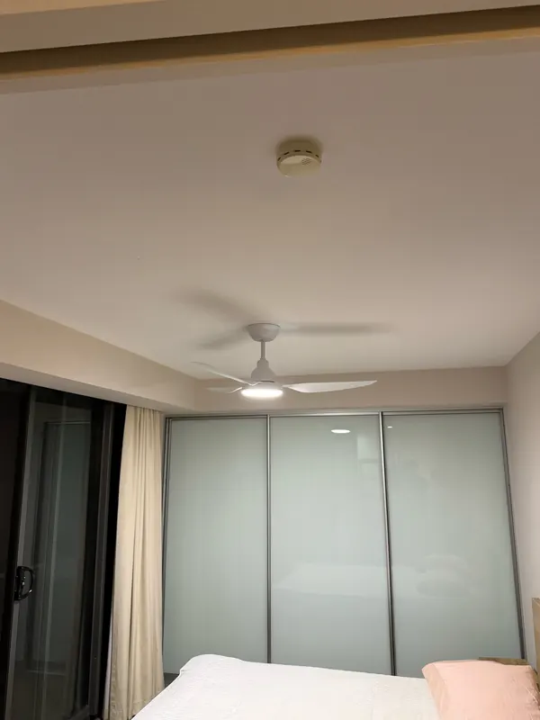 White ceiling fan with an integrated LED light in a bedroom, installed by OWCA Electrical